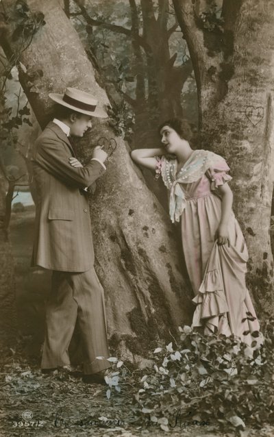 Postcard of lovers carving a heart on a tree, sent in 1913 by French Photographer